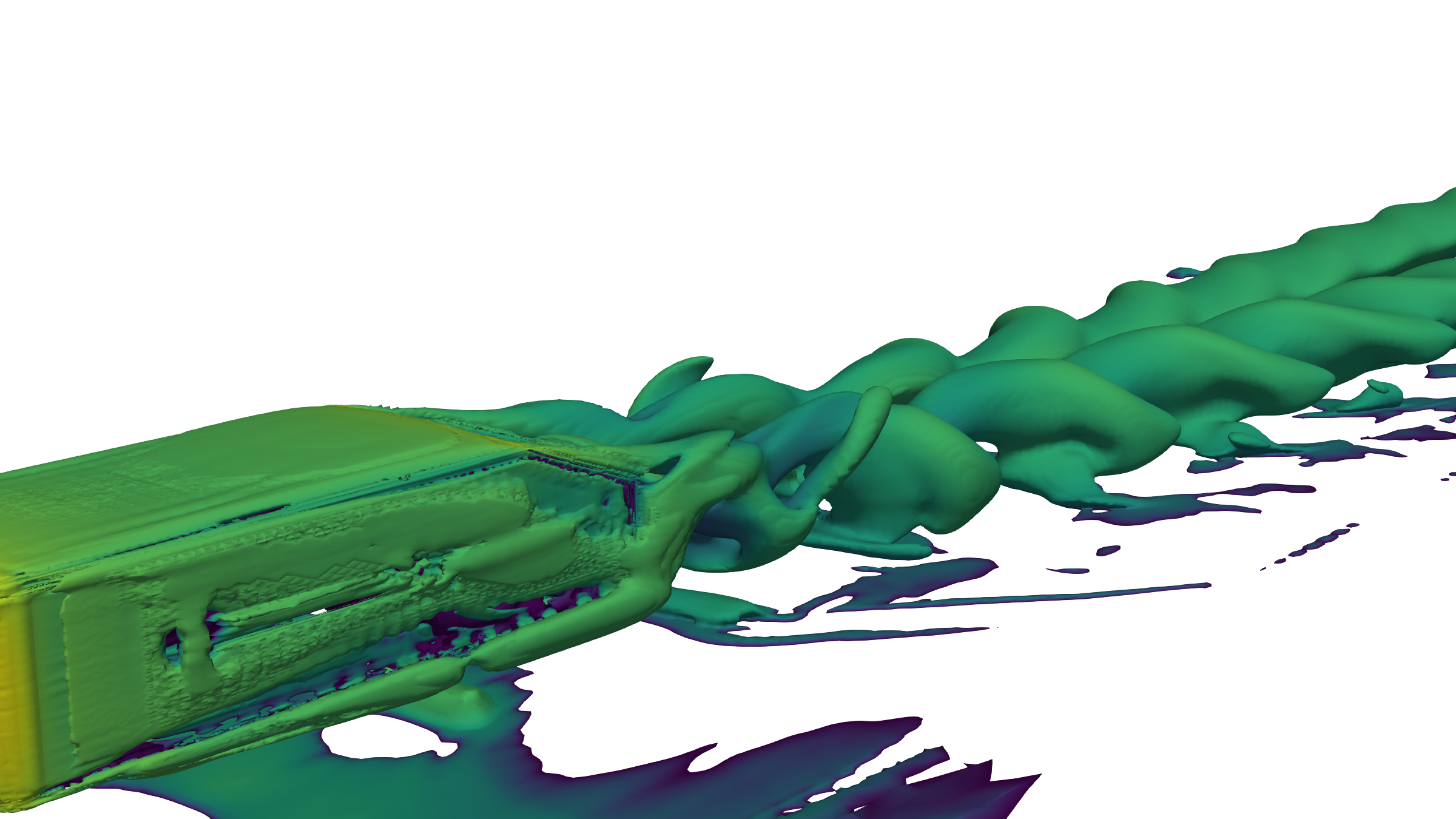 Q-criterion isosurfaces behind an Ahmed body, rendered in green: a pair of long counter-rotating trailing vortices springing from the slant edges and breaking into smaller structures downstream.