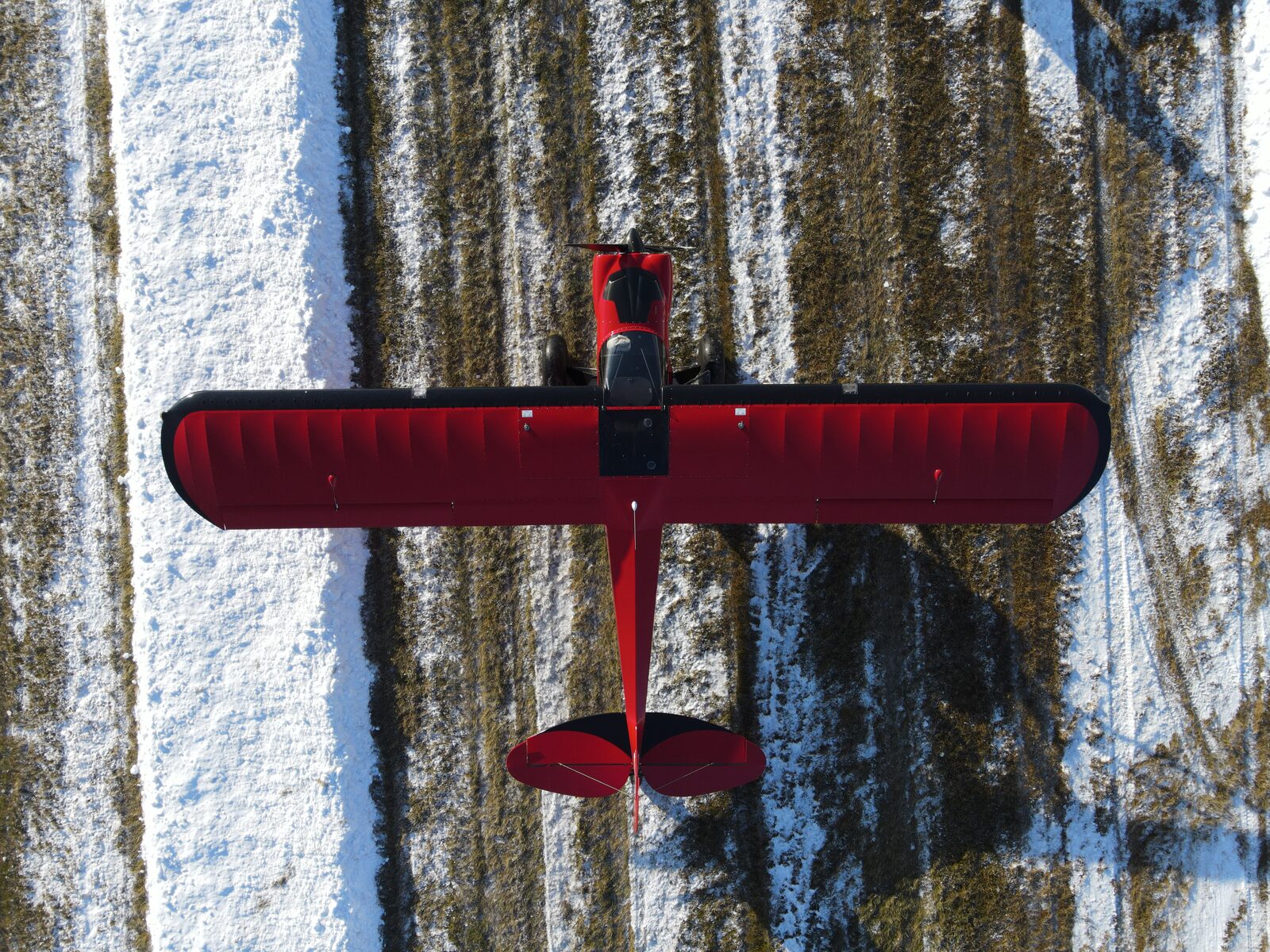 Red tailwheel aircraft, overhead aerial