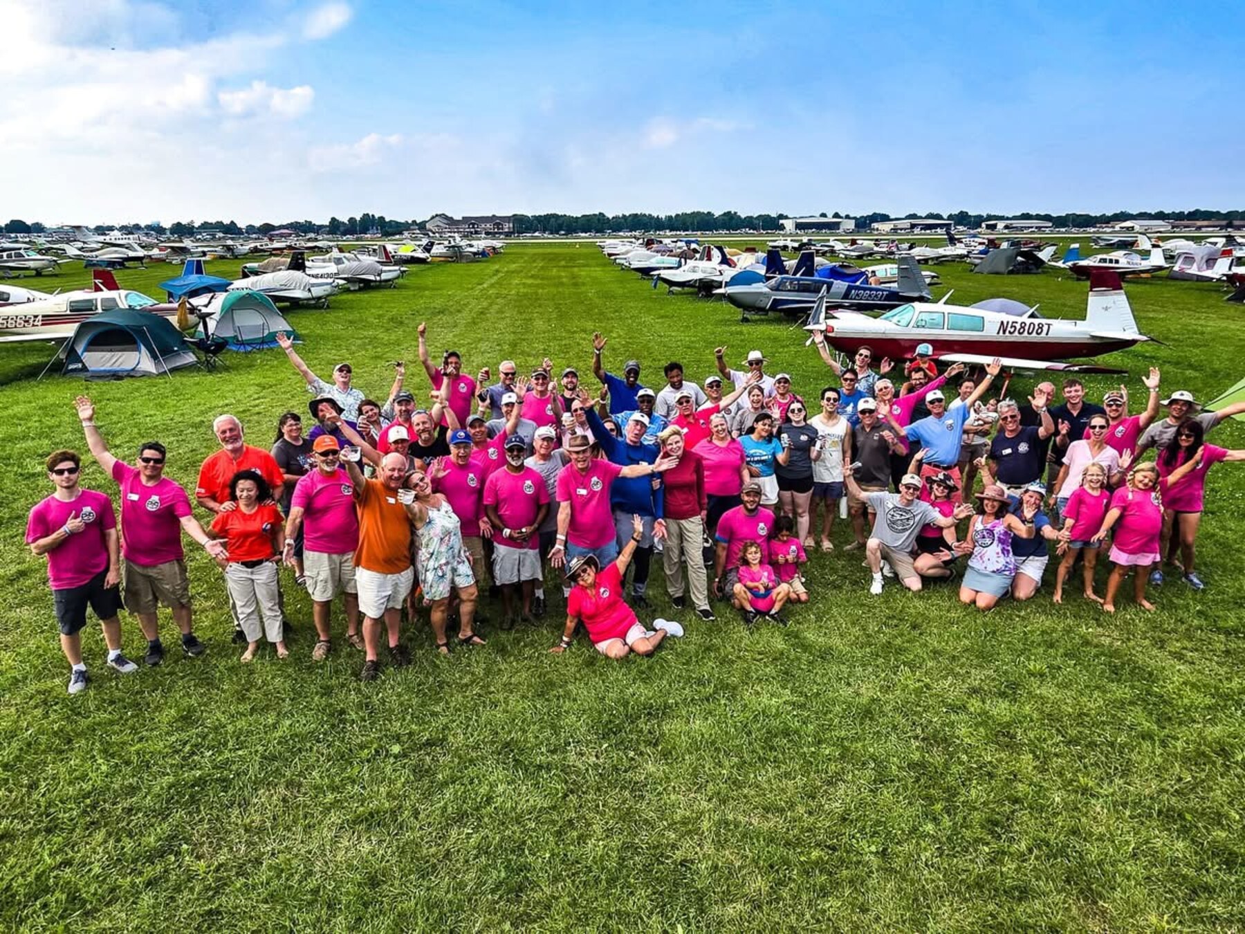 Mooney Caravan 2025 crew on the Oshkosh grass