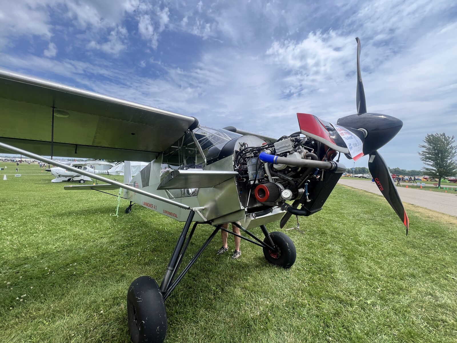 Tailwheel aircraft with engine partly exposed, propeller forward