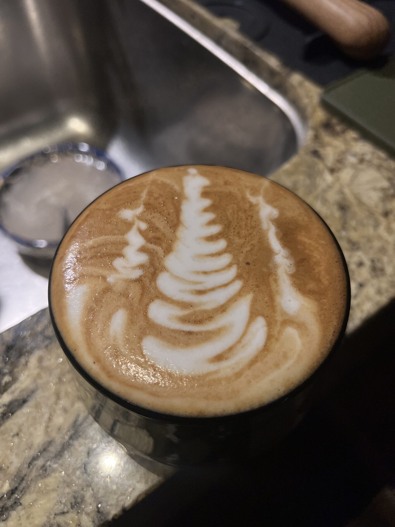 Layered christmas-tree art in a clear glass.