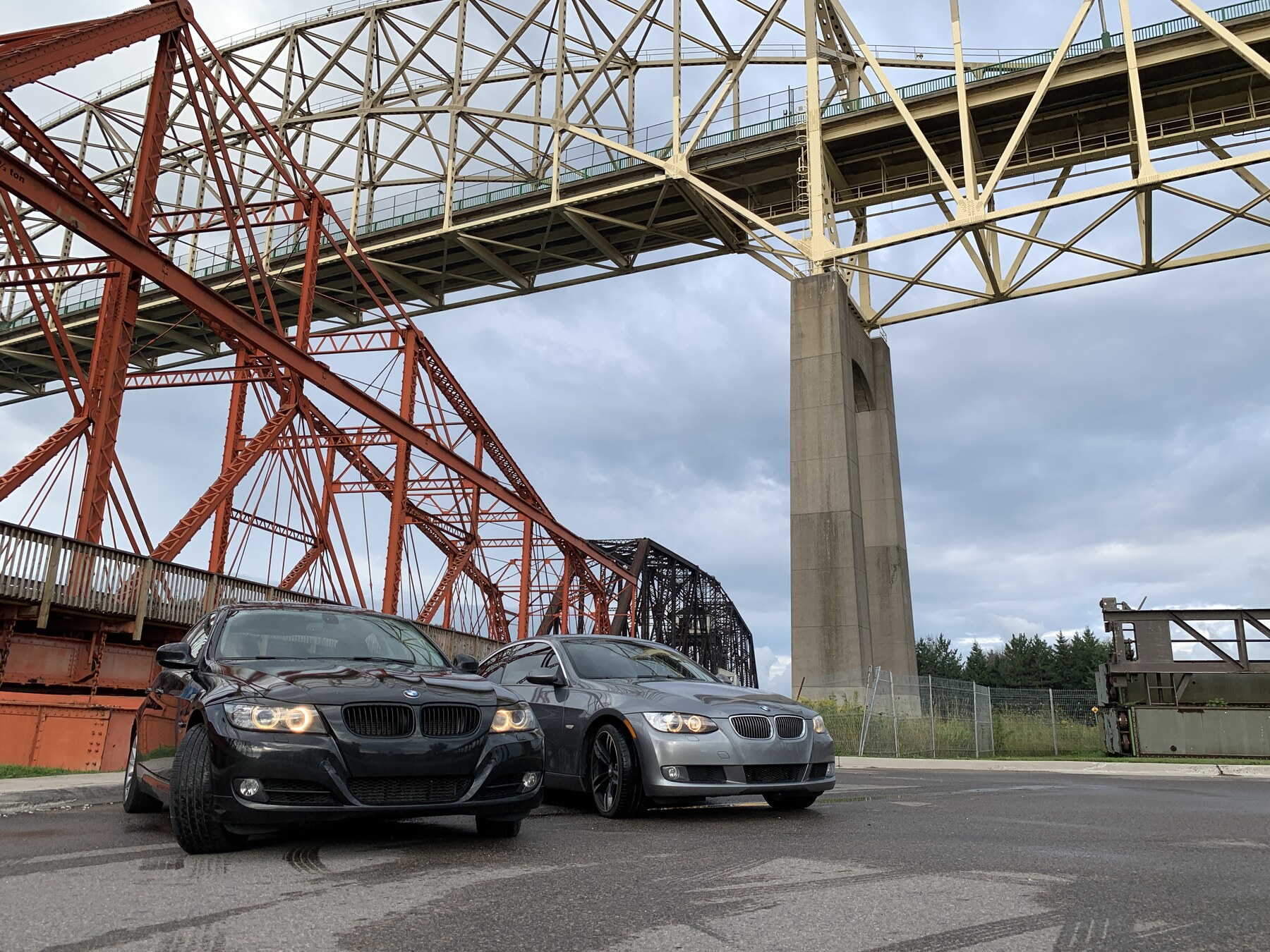 E90 + E92 under an orange steel bridge in Ontario