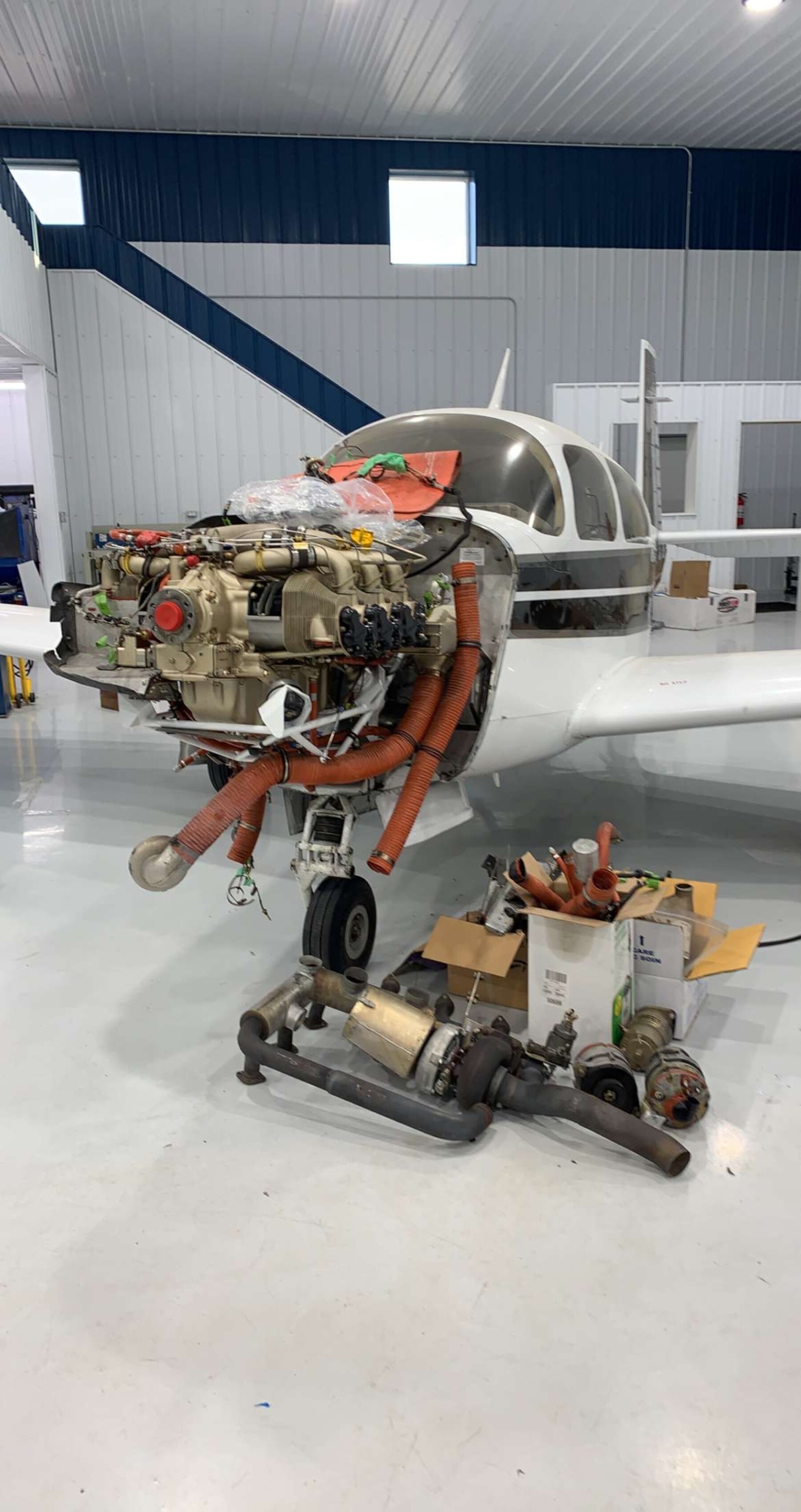 Mooney aircraft engine, cowling removed for cylinder teardown in a hangar