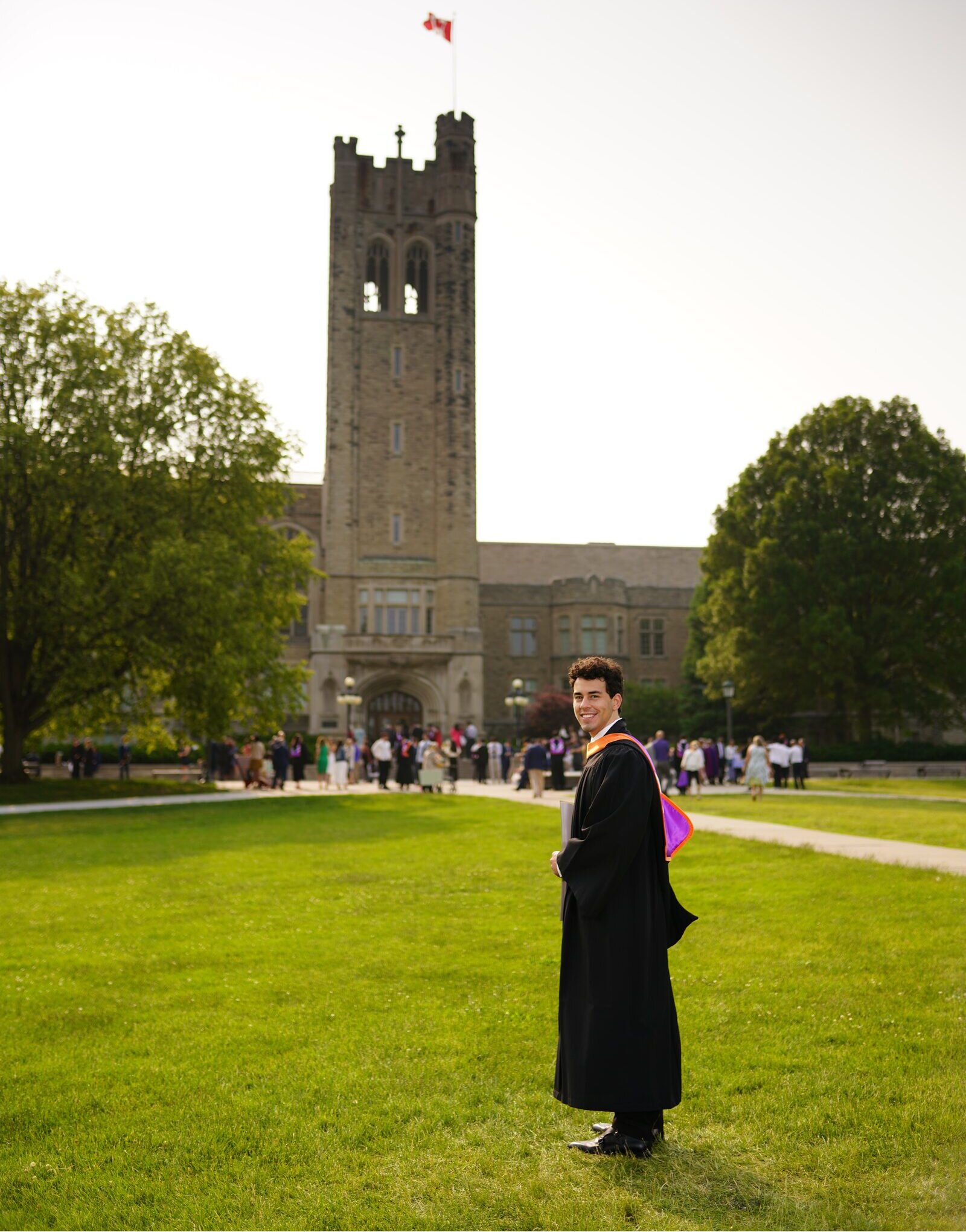 Mason Shopperly in convocation regalia in front of University College tower at Western, May 2025.