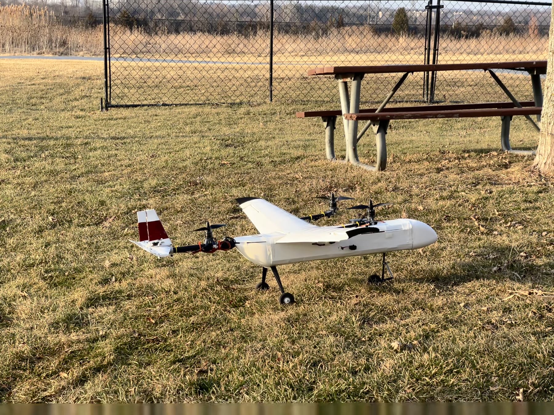 Stratus tiltrotor UAV on grass, pre-flight