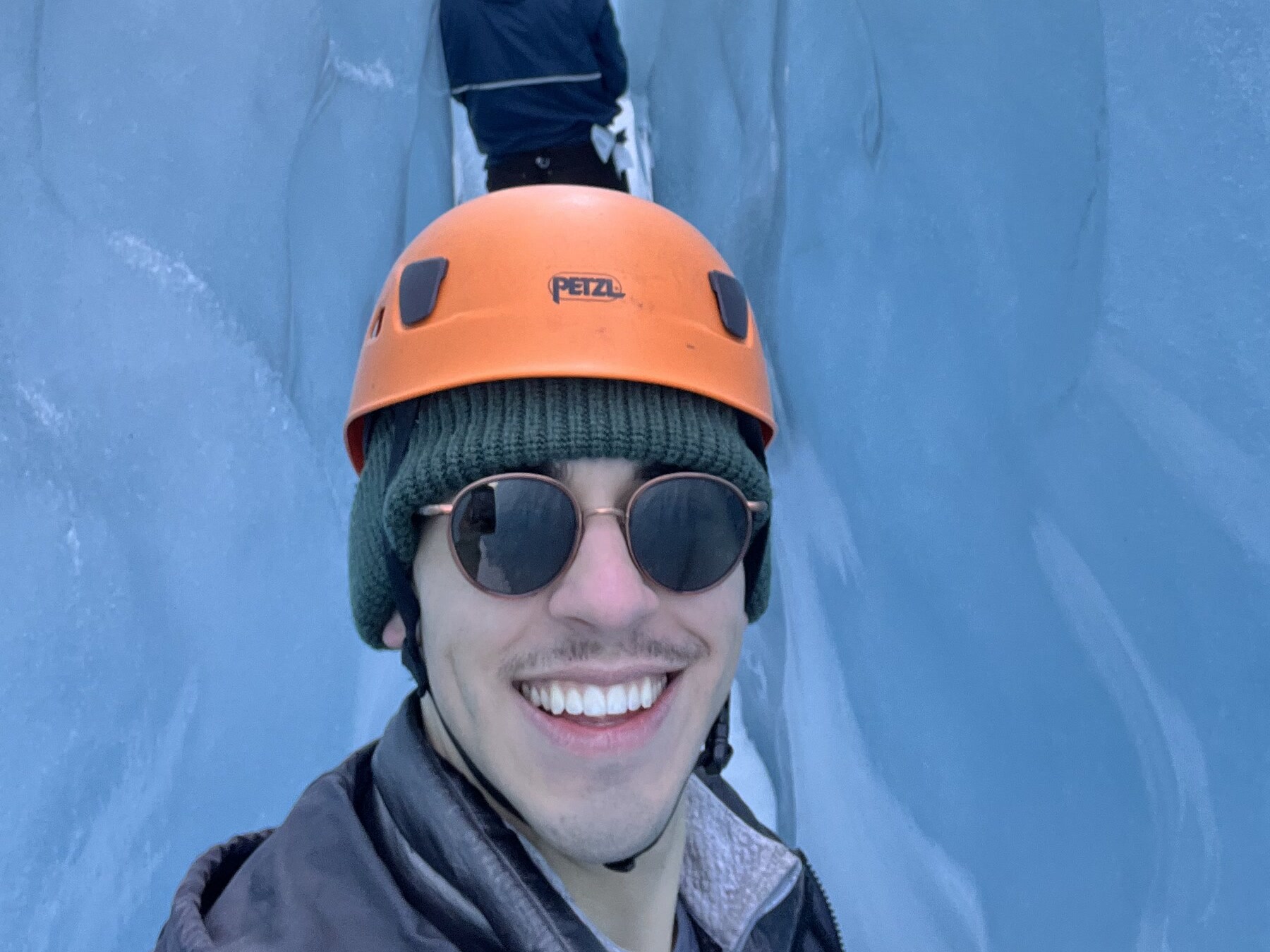 Mason in a glacier ice cave, Iceland